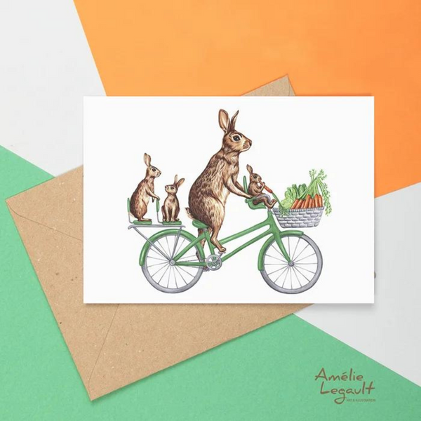 Carte de souhaits La famille de lapins à vélo